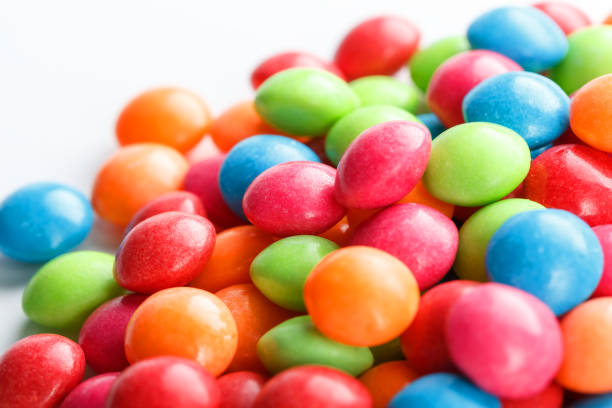 istock A rainbow of color from multicolored candies close-up, multi-colored glaze dragee on a white background 1147091391