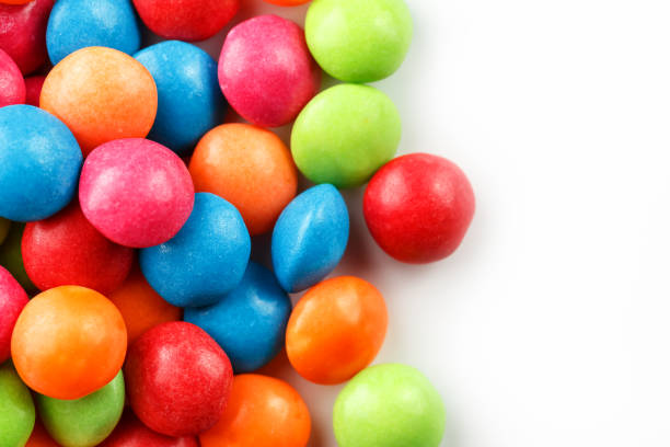 istock A rainbow of color from multicolored candies close-up, multi-colored glaze dragee on a white background 1147091489