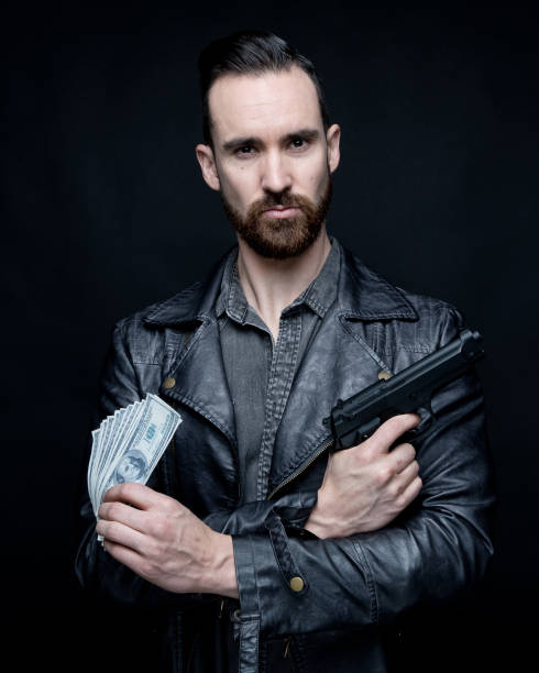 istock Man holding drugs and cash 1147092499