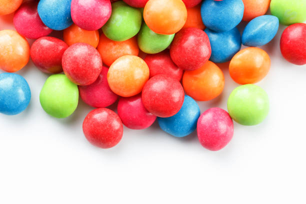 istock A rainbow of color from multicolored candies close-up, multi-colored glaze dragee on a white background 1147092514