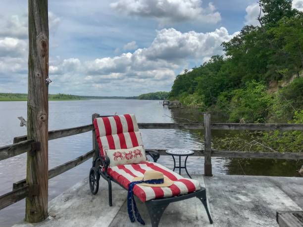 istock Red and white striped lounge chair next to beautiful river 1147093046