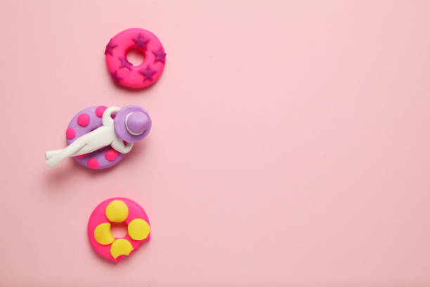 istock Plasticine people relaxing on inflatable donut lilo in pool. Cartoon summer relaxing and holidays 1147094701