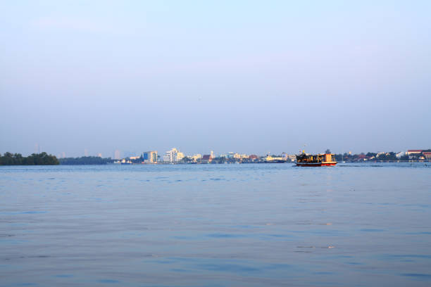 istock Beautiful sunrise on the river with Cargo ship and boat in Thailand 1147096445