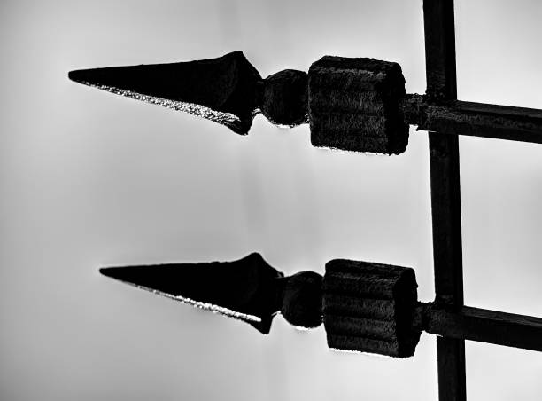Diagonal black and white detailed fence spikes object background