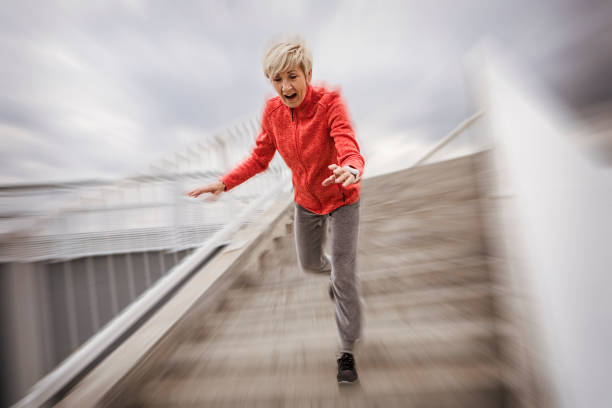 donna anziana caduta gradini di pietra all'aperto - falling people tripping senior adult foto e immagini stock