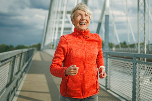 istock Happy athletic senior woman running 1147098221