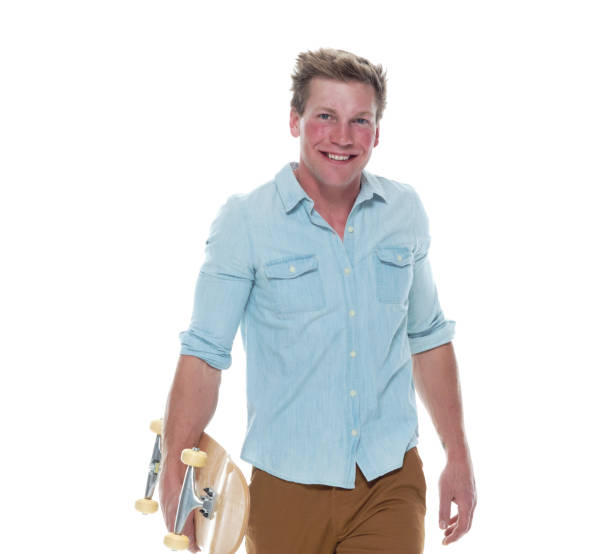 istock Casual well dressed man walking with a skateboard 1147098946