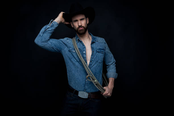 istock Handsome sexy cowboy on black background 1147099195