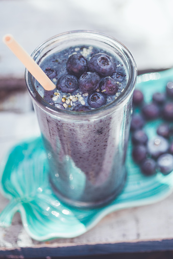 Refreshing blueberry smoothie with bamboo straw