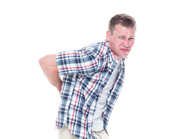istock Handsome man in shirt and shorts has a back ache 1147100733
