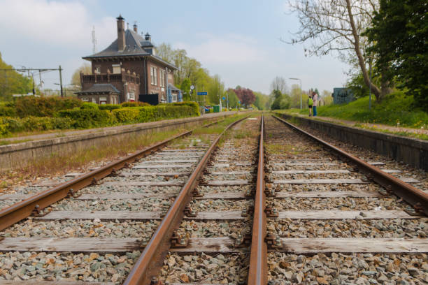 Dutch country train station Schin op Geul, Limburg, the Netherlands - May 5 2019: country train station Schin op Geul with railway track low angle in foreground tasrail stock pictures, royalty-free photos & images