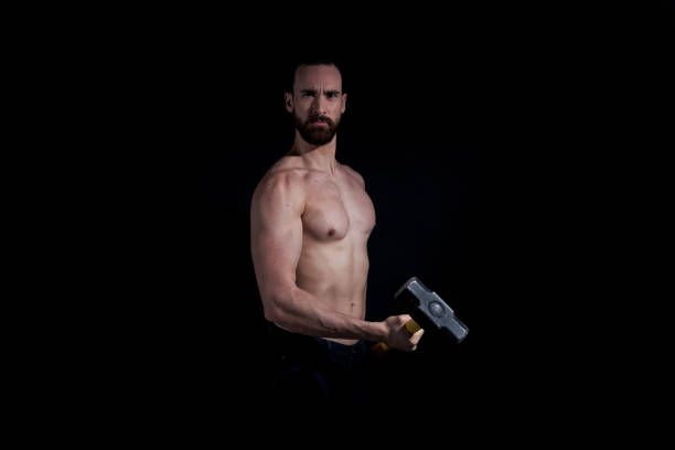 istock Manly shirtless man holding a hammer 1147102425