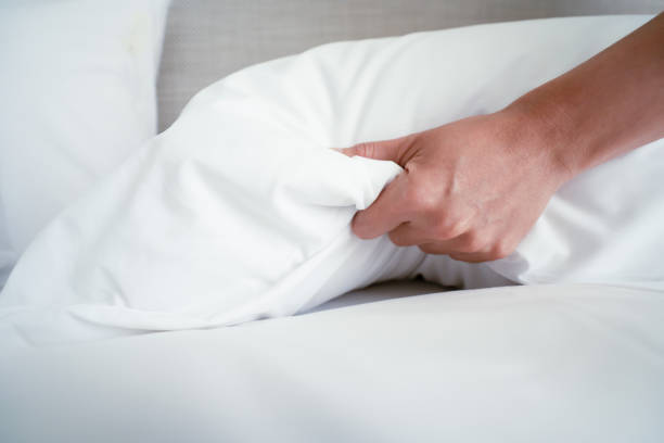 istock Female Hand set up white bed sheet in room hotel 1147103715