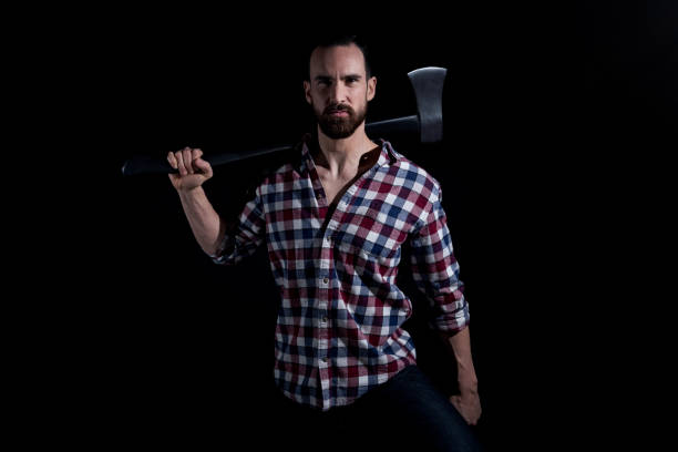 istock Attractive lumberjack man holding an axe 1147105667