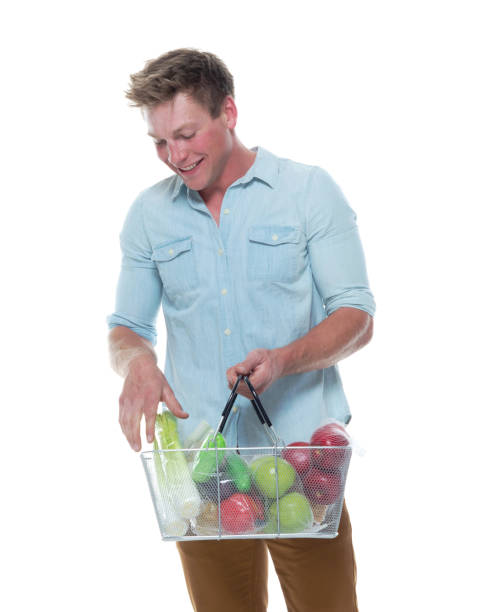 istock Handsome male holding shopping basket with vegetables 1147105836