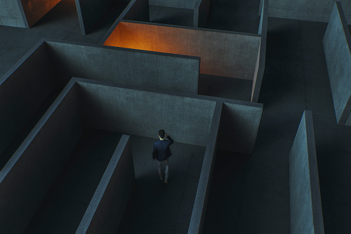 Young businessman lost in maze. This is entirely 3D generated image.