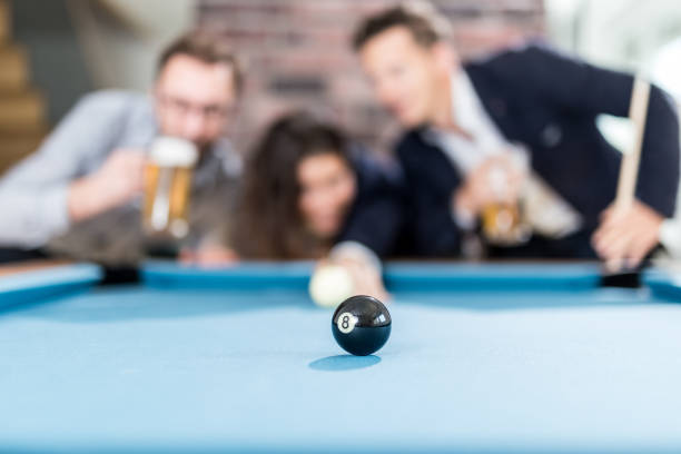 happy friends enjoying playing snooker game and drinking beer. - snooker table imagens e fotografias de stock