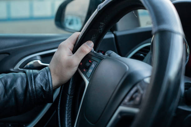 istock Male driver holding steering wheel while driving 1147108561