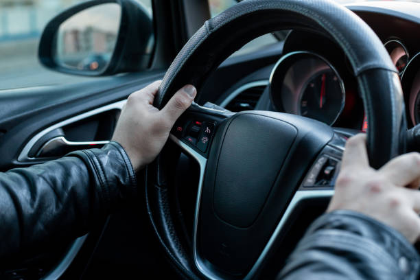 istock Male driver holding steering wheel while driving 1147108646