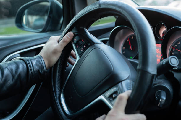 istock Male driver holding steering wheel while driving 1147108756