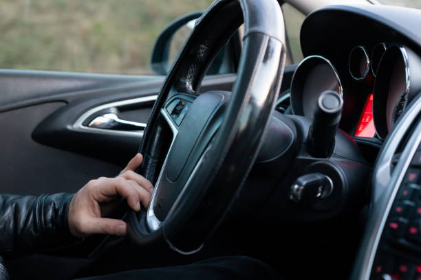 istock Male driver holding steering wheel while driving 1147109842