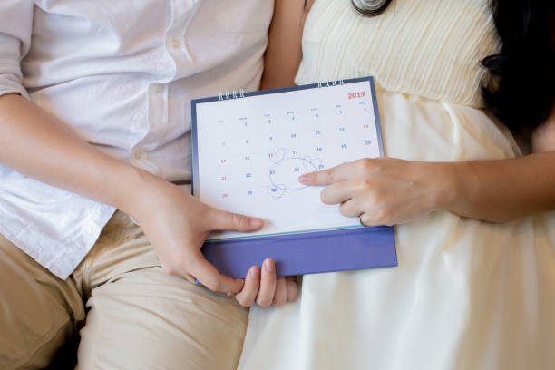 Couple showing baby birth date