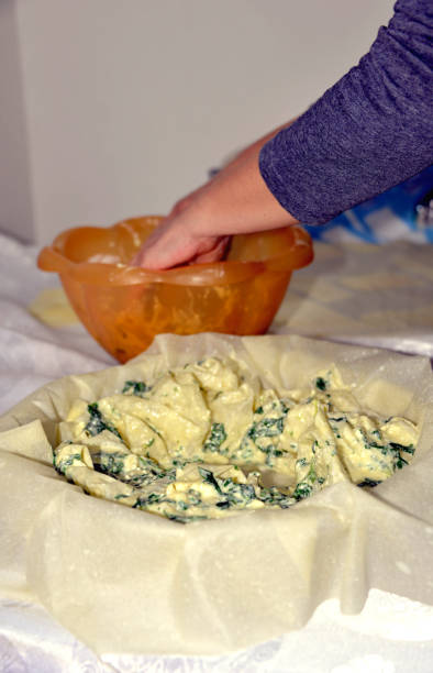 istock Preparing one nice pie of crusty dough with cheese and spinach 1147115973