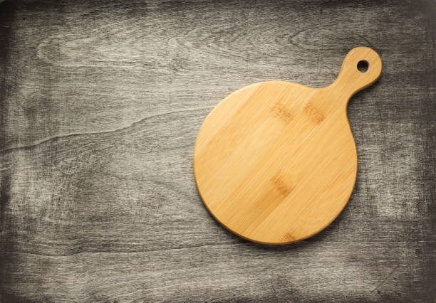 istock cutting board on wooden background 1147117070