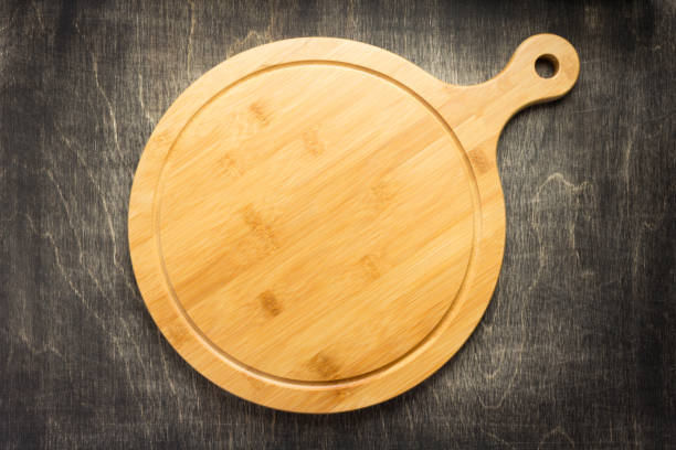 istock cutting board on wooden background 1147117074