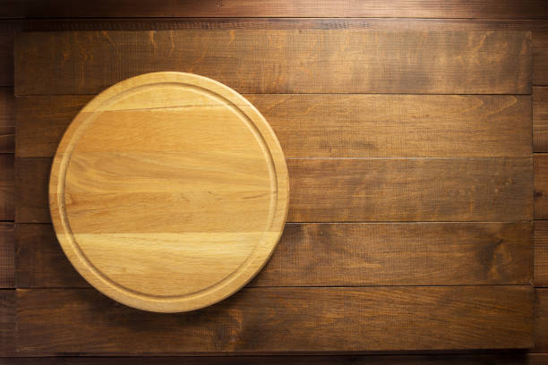 istock cutting board on wooden background 1147117305