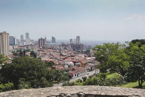 Panorama photo of Cali in Colombia, viewed from a higher perspective. Looking towards CBD of Cali on a hazy but sunny day.