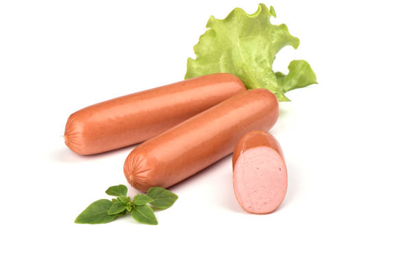 istock Two fresh boiled sausages and half, lettuce and basil isolated on white background. 1147120168