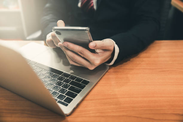 istock Business man using smart phone and laptop 1147120966
