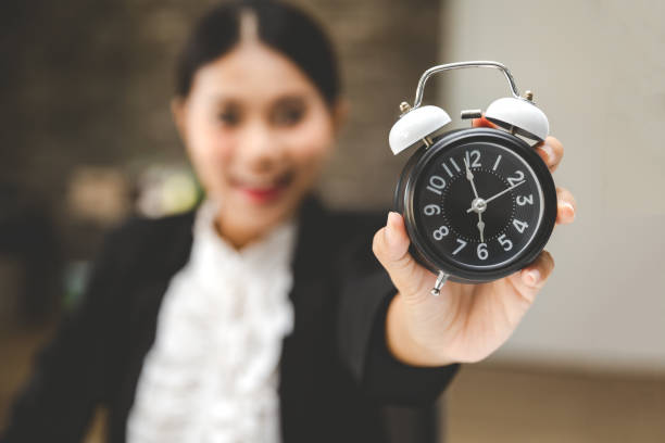 istock Business woman with alarm clock 1147120978
