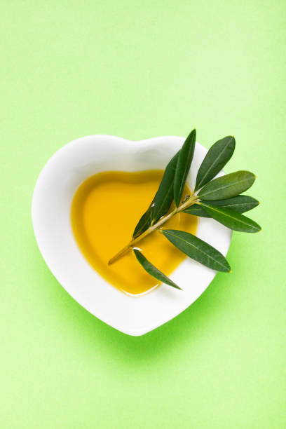 istock extra virgin olive oil with olive branch 1147122233