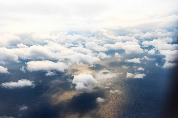 istock Clouds from a window of a commercial plane with sea. 1147123838