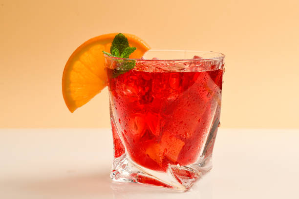 istock Red fresh drink with ice, grapefruit and mint on an beige background. Space for text or design. 1147125427