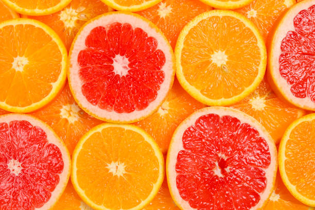 istock Slices of oranges and a grapefruits as a background. 1147125443