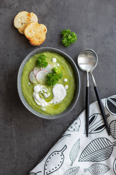 istock Soup with broccoli and cream  and spoon on gray background 1147125628