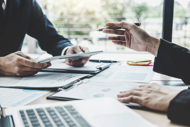 istock Two executive discussing company growth project success financial statistics, Partner meeting professional investor working start up project for both company with document, laptop and digital tablet 1147125691