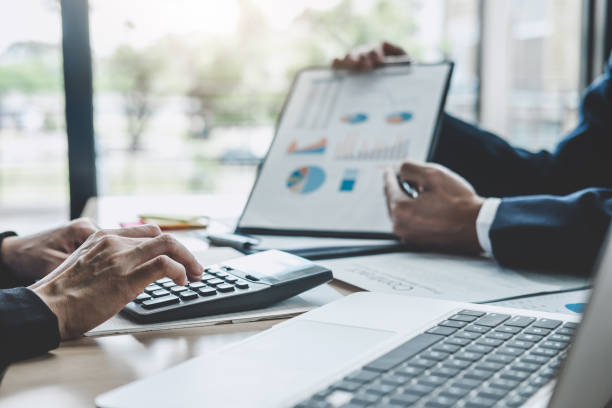 istock Two executive discussing company growth project success financial statistics, Partner meeting professional investor working start up project for both company with document, laptop and digital tablet 1147125694