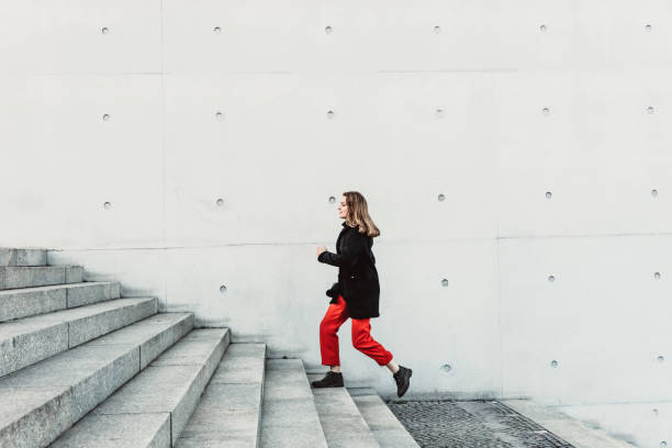 istock Woman climbing up the stairs 1147126645