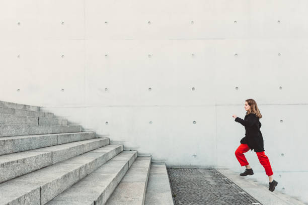 istock Woman climbing up the stairs 1147126733