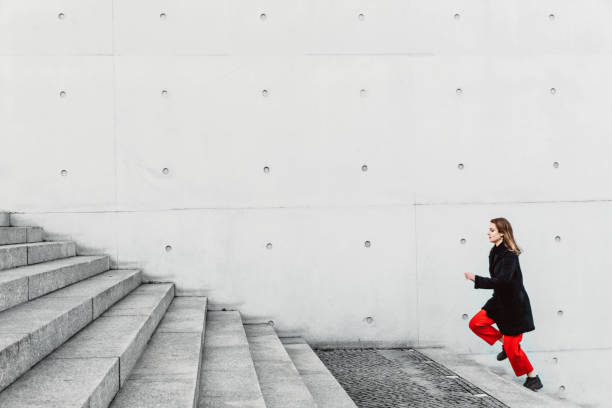 istock Woman climbing up the stairs 1147126822