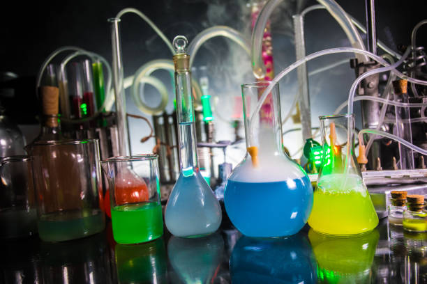istock Pharmacy and chemistry theme. Test glass flask with solution in research laboratory. Science and medical background. Laboratory test tubes on dark toned background 1147126944