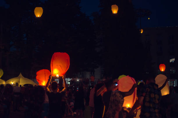 Chinese flying lanterns are taking off . Holiday evening and celebrating.