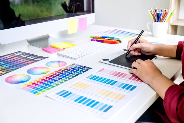 istock Image of female creative graphic designer working on color selection and drawing on graphics tablet at workplace 1147128298