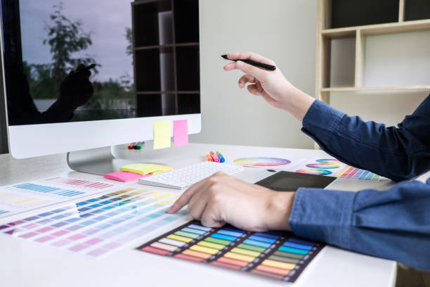 istock Image of male creative graphic designer working on color selection and drawing on graphics tablet at workplace with work tools and accessories 1147128310