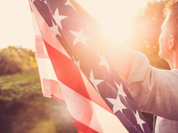 istock Handsome, young man waving an American flag 1147128338
