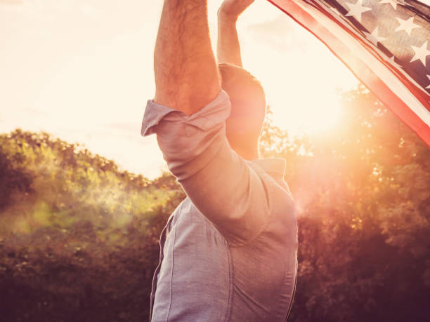 istock Handsome, young man waving an American flag 1147128362